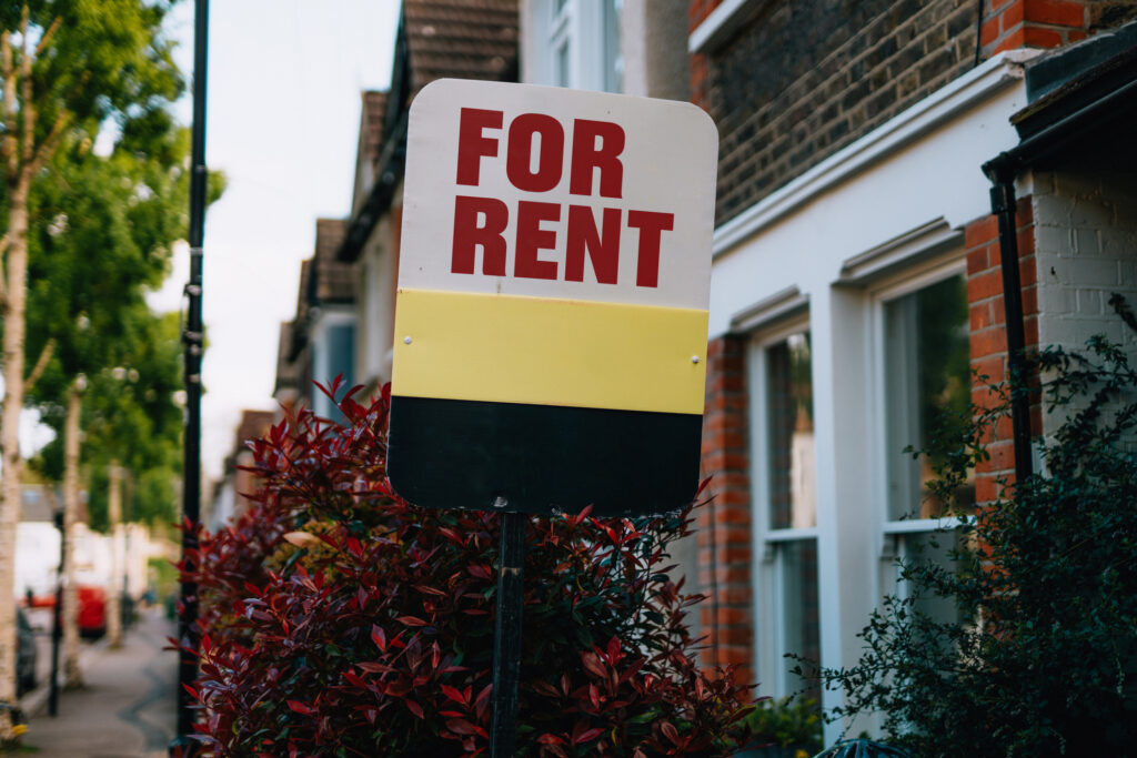 For rent sign in front of house. Rental property management. Economy and property market.