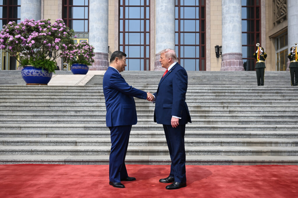 .S. President Donald Trump (R) is greeted by Chinese President Xi Jinping at the Great Hall of the People on May 14, 2026 in Beijing, China.