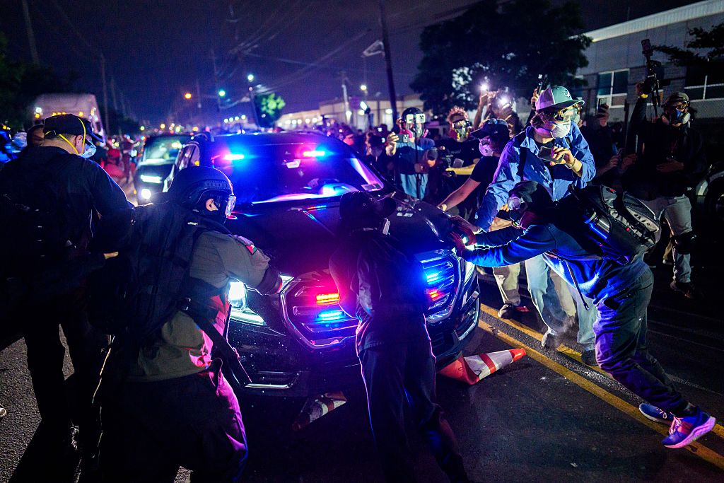 NEWARK, NEW JERSEY - MAY 29: Protestors block an Immigration and Customs Enforcement (ICE) vehicle outside Delaney Hall which is being used as an ICE detention center on May 29, 2026 in Newark, New Jersey.