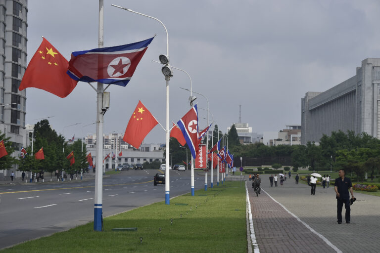 TOPSHOT - The national flags of North Korea and China are displayed on a street in Pyongyang on June 8, 2026. Chinese President Xi Jinping arrived in Pyongyang on June 8, state news agency Xinhua reported, for his first official visit to North Korea since