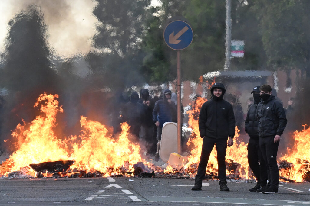 Youths gather infront of a burning barricade on Duncairn Gardens on June 9, 2026 in Belfast, Northern Ireland.