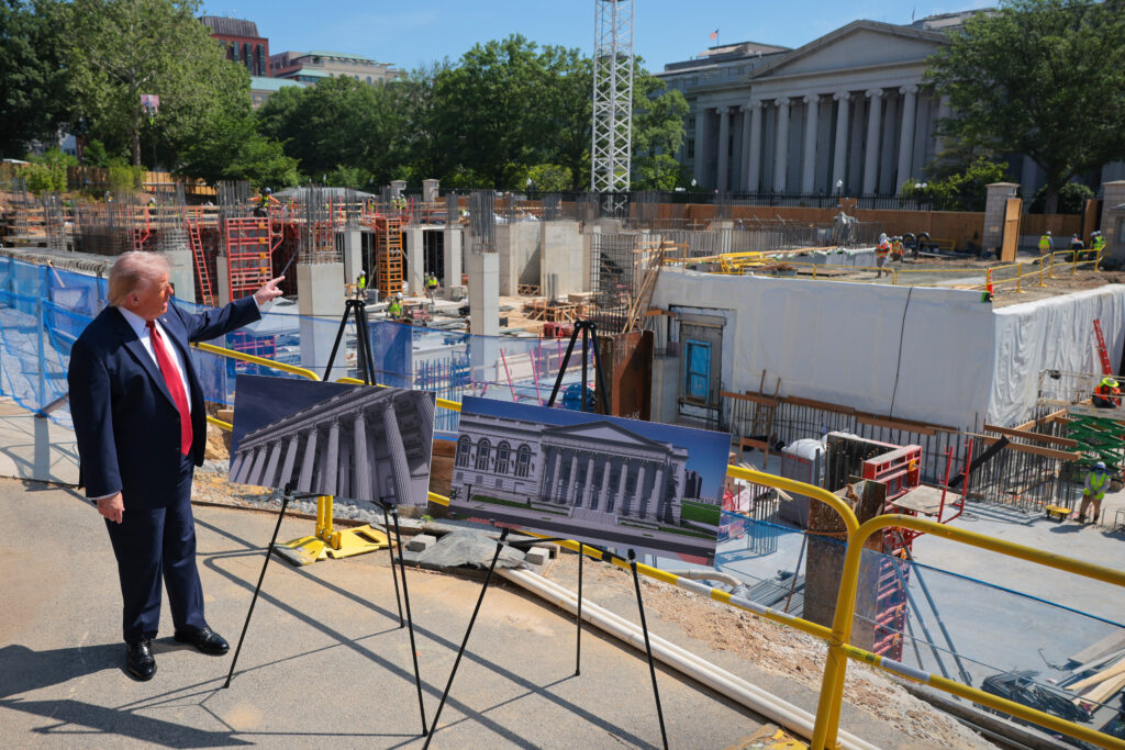 President Donald Trump speaks to the media alongside posters of his proposed White House ballroom amid construction at the White House on May 19, 2026 in Washington, DC.